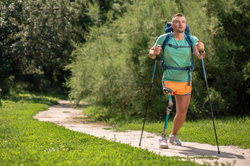 Wall Mural - Confident young man with paralysis trying Nordic walking