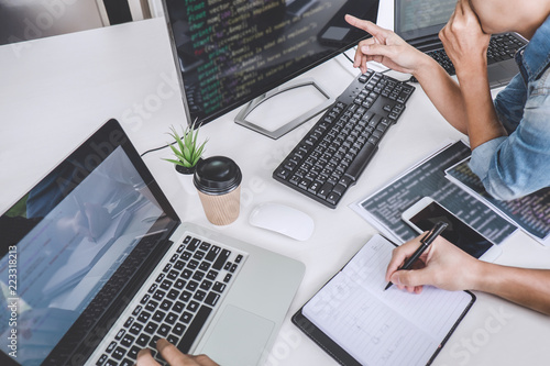 Fotomural Writing codes and typing data code technology, Programmer cooperating working on