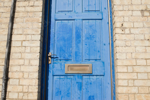 Brass Door Letterbox On A Blue Vintage Front Door On A Yellow