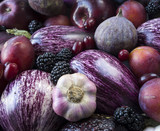 Fototapeta Sawanna - Background of fresh vegetables and fruits. Purple eggplant, plums, figs, apples and garlic. Top view. Purple food.
