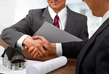 Canvas Print - Business people handshaking at meeting on background