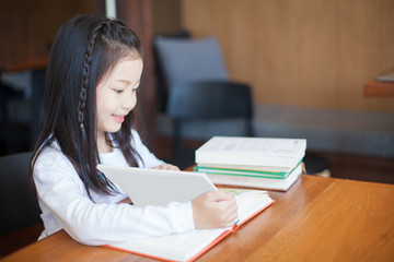 Asia cute little kids are happy to read a books 