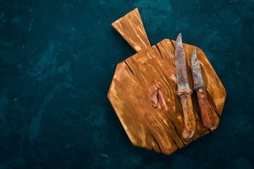 Wall Mural - Kitchen old wooden board. On a black background. Free space for text. Top view.