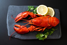 Lobster With Vegetable And Lemon On Black Slate Plate