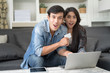 © Nattanon - In Selective Focus Of Happy Lover Couple Holding White Credit Card In Hand While Using Laptop Computer Shopping Online.