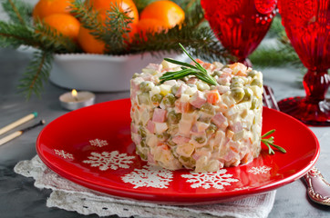 Russian traditional salad Olivier with vegetables and meat