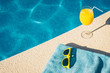 © andrey gonchar - Fashion sunglasses, towel and juice near the pool