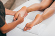 © LIGHTFIELD STUDIOS - cropped view of woman having feet massage in spa salon