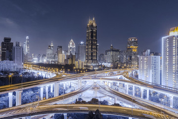Wall Mural - aerial view of buildings and highway interchange at night in Shanghai city