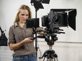 Beautiful woman operating a video camera rig