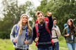 © Syda Productions - travel, tourism, hiking and people concept - group of smiling friends or travelers with backpacks