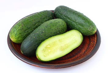 Poster - Cucumbers on a plate on a white background isolated