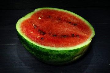 Poster - Half watermelon on a dark background