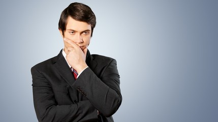 Poster - Thoughtful businessman portrait on background