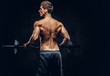 © Fxquadro - Back view of shirtless man with stylish hair and muscular ectomorph doing the exercises with the barbell.