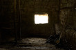 © Gecko Studio - Old rustic clay cowshed interior with window and manure for fertilizer inside
