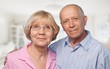 © BillionPhotos.com - Portrait of happy senior couple smiling in blurred garden