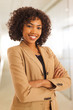 © Mark Adams - Attractive businesswoman with arms crossed smiling at camera in office building