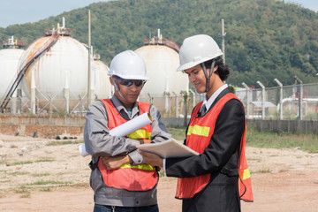 two engineer on site with oil refinery