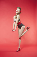 Portrait Of Girl In Pin Up Style On Red Background
