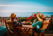 Young Couple Have Breakfast On Balcony Terrace With Sea View