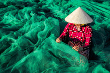 Young Vietnamese Woman Sitting Repair The Fish Net In The Morning,traditional Fisherman.