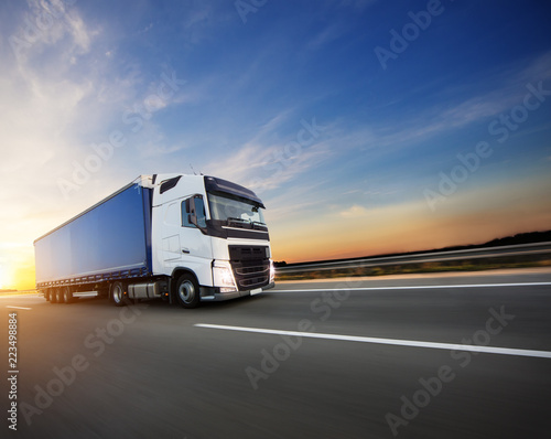 Fotomural Loaded European truck on motorway in sunset