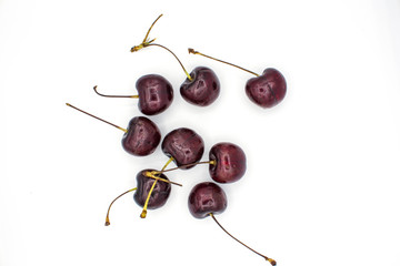 Ripe red fresh cherry on a white isolated background.