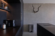 © Jordi Huisman - Interior of a modern apartment on the sixth floor of a new apartment building in the Houthavens area in Amsterdam. Kitchen with decorative antlers on the concrete wall.