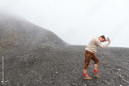 Fotomural Humorous individual moonwalking in a moonlike landscape in the mountains of the