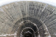 Beautiful view down the hole of the concrete water intake tower at the Moiry dam near Grimentz, Switzerland
