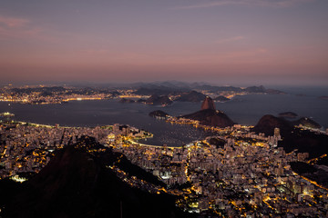 Wall Mural - Brazil, Rio de Janeiro. Meeting the sunset. Top view of the city, lanterns, ocean, hills