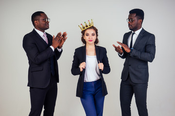 beautiful indian business woman and two African American businessman applauding in the studio on a white background. multinational mixed race teamwork business partners