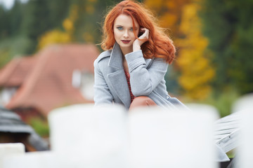 Wall Mural - Outdoors autumn portrait of beautiful woman with red hair