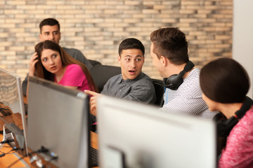 Poster - Young people playing video games at tournament