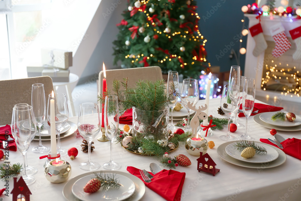 Stylish table setting with burning candles and Christmas decorations