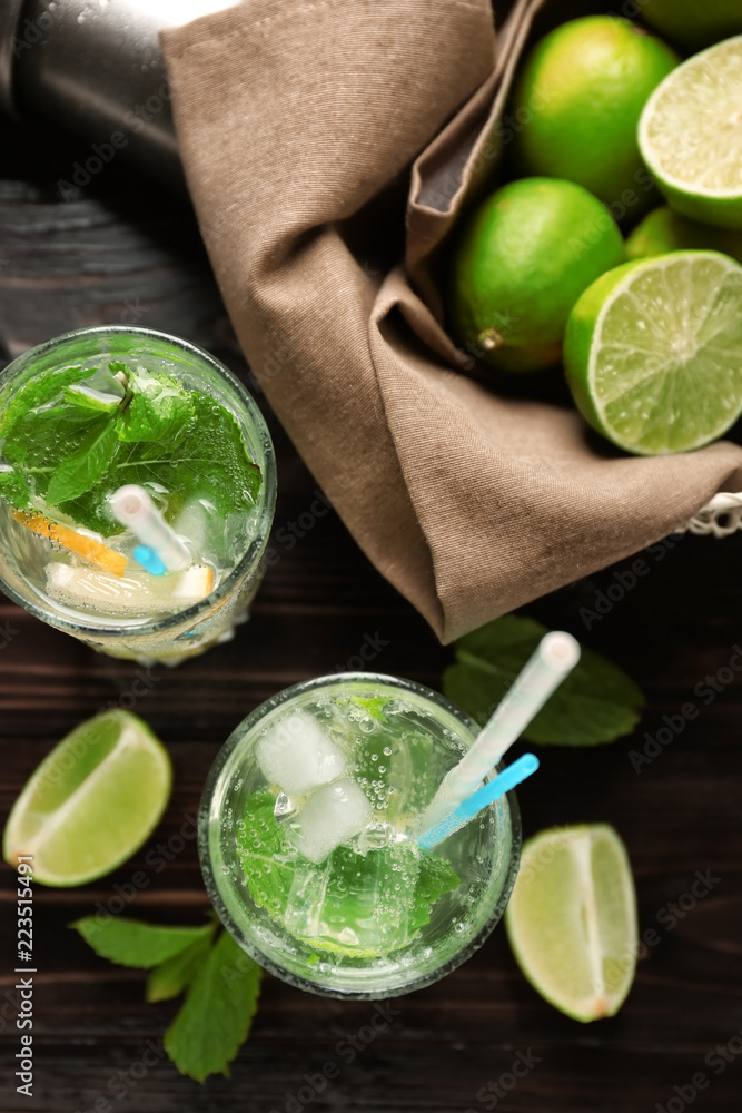 Glasses of fresh mojito on wooden table