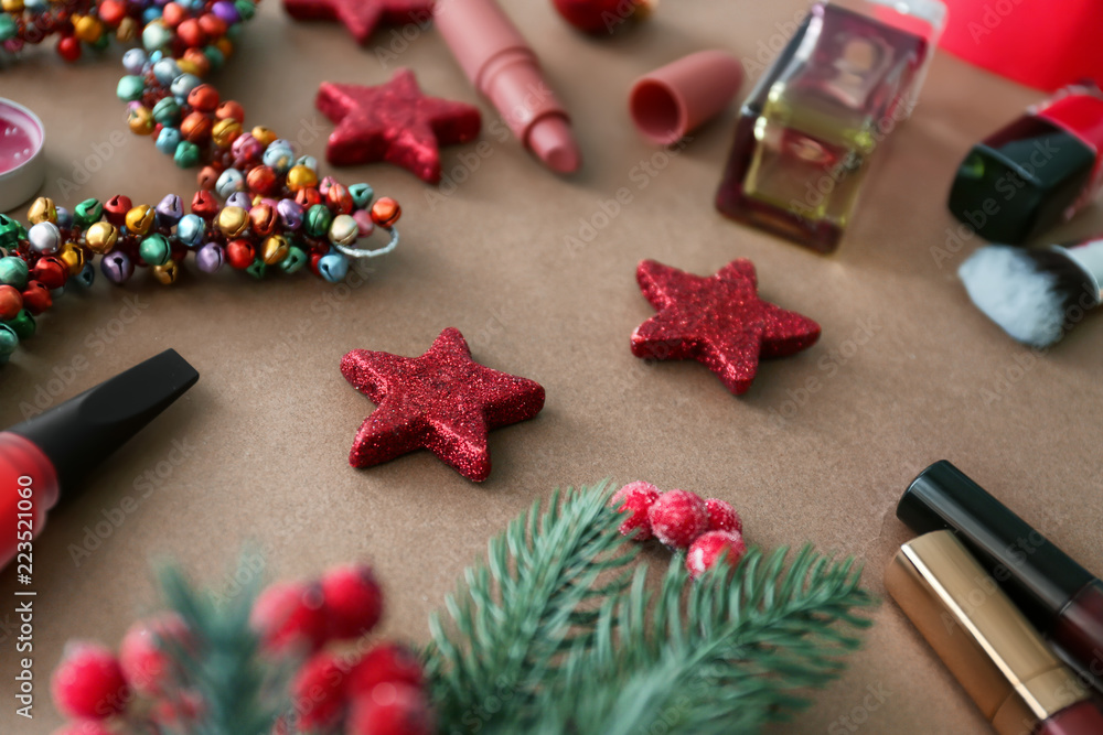 Set of cosmetics with Christmas decorations on color background
