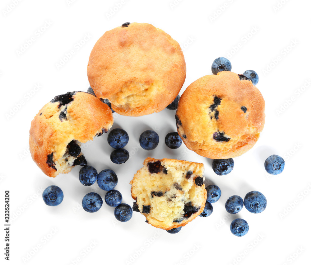 Tasty blueberry muffins on white background