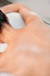 © LIGHTFIELD STUDIOS - partial view of woman with needles on body having acupuncture therapy in spa salon
