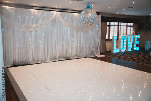 Wedding Dance Floor And Big Blue Illuminated Love Letters On A