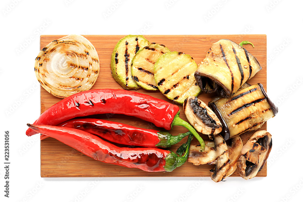 Wooden board with tasty grilled vegetables on white background