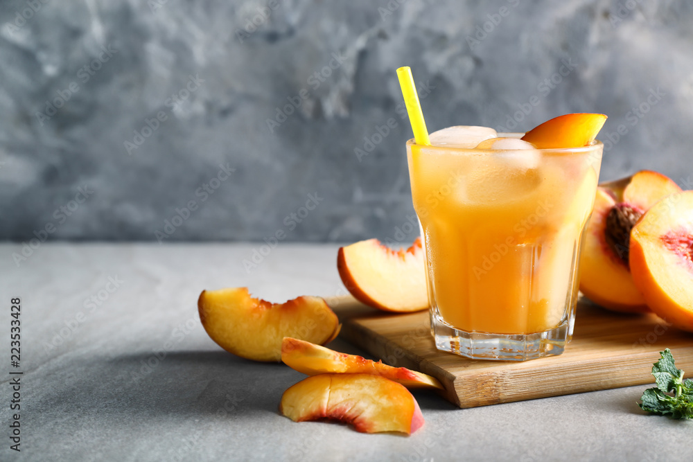 Fresh summer cocktail in glass on grey table
