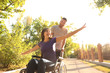 © Pixel-Shot - Happy young woman in wheelchair and her husband outdoors