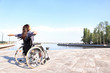 © Pixel-Shot - Happy young woman in wheelchair outdoors