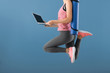 © Pixel-Shot - Young woman with yoga mat and laptop jumping on color background. Concept of balance between rest and work