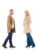 © LIGHTFIELD STUDIOS - stylish couple posing in beige autumn coats, isolated on white