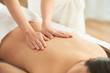 © DragonImages - Crop hands of therapist massaging back of unrecognizable female client in spa salon