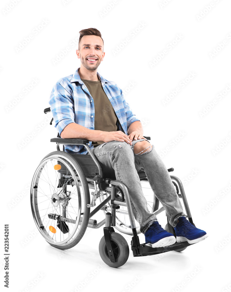 Young man sitting in wheelchair on white background
