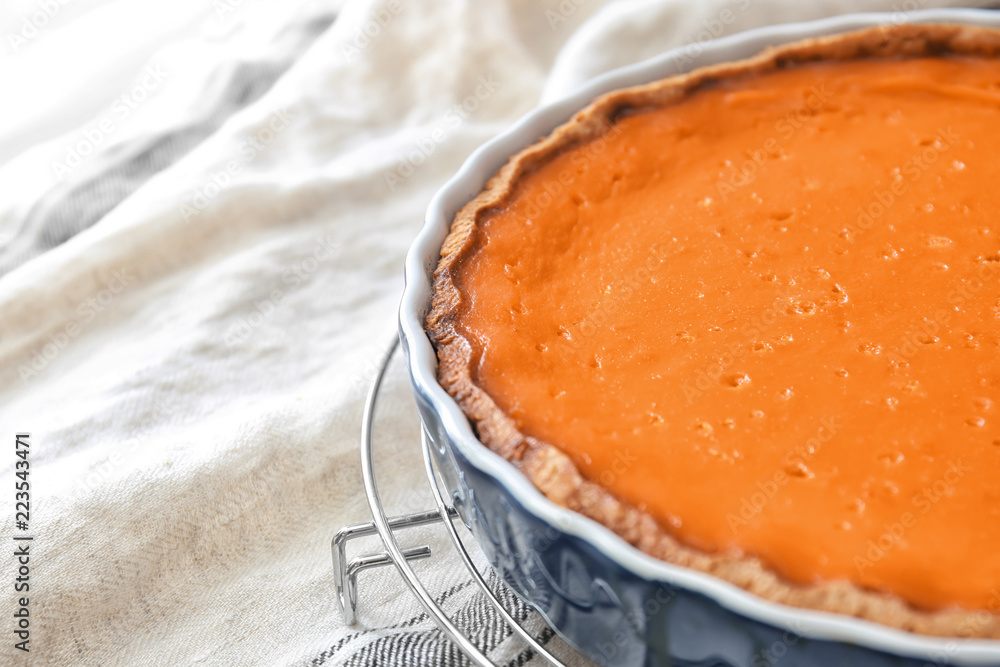 Baking dish with tasty pumpkin pie on table, closeup